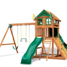Wooden playhouse with slides, a climber, a swing, and a trap bar