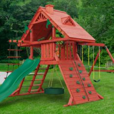 A wooden SUN PALACE SWING SET with a green slide and swings.
