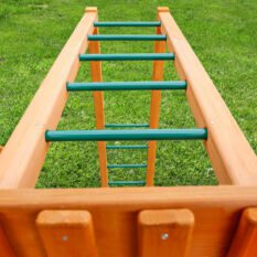 A wooden climbing frame with green and orange ladders.