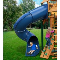 A child is playing on a Radical Ride Tube Slide in a backyard.