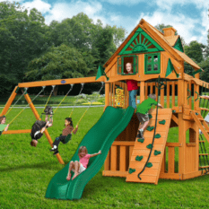 A wooden play set with a slide and swings.