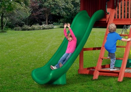 Child sliding on a green slide