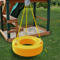 A yellow 360° Turbo Tire Swing hanging from a wooden swing set.