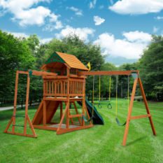 A wooden play set in a grassy area.