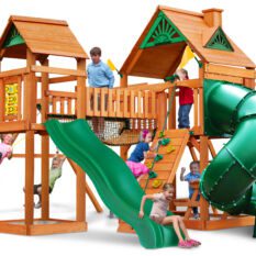 Kids playing on yellow swing set with a roof and green slides