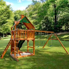 A Chateau Swing Set in a grassy area.