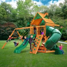 A Chateau w/ Tube Slide Swing Set with a green slide and swings.