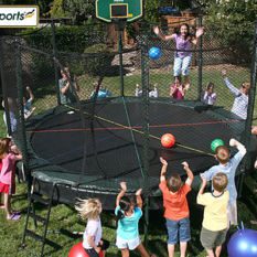 A group of children playing around the Double Bounce Trampoline.