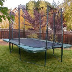A backyard with a Variable Bounce 10 x 17 Ft.