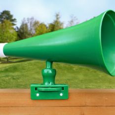 A green Megaphone sits on top of a wooden fence.