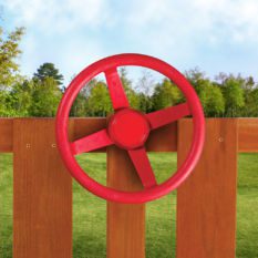 A red Steering Wheel on a wooden fence.