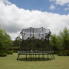 A SpringFree Medium Oval Smart Trampoline in a grassy area.