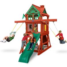 Kids playing on red and green swing set with slide and gable roof