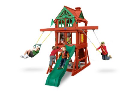 Kids playing on red and green swing set with slide and gable roof