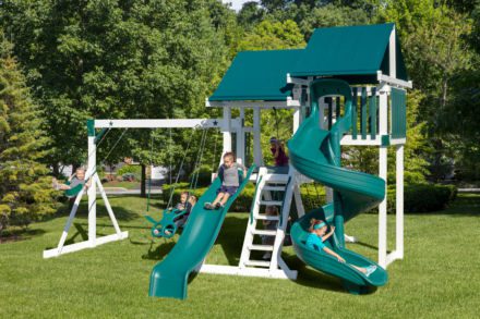 A green playground set with a slide and swings.