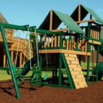 Green wooden swing set with two towers