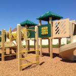 Wooden playground with green gable roof