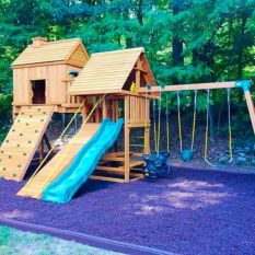 Wooden swing set with a blue slide