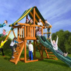 Kids playing on wooden tower with swings and a slide