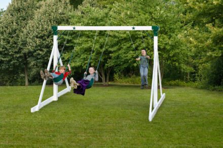 Two children swinging on a Free Standing Swings System in a yard.