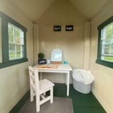 A VinylNation Royal Cottage Clubhouse with a desk and chair.