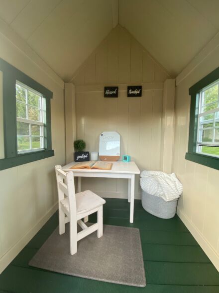 A VinylNation Royal Cottage Clubhouse with a desk and chair.