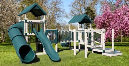 A green and white VinylNation STAR PALACE playground set with a slide.