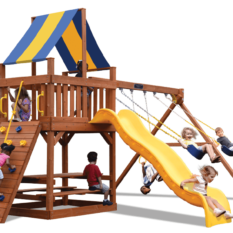 Children playing on a wooden playground with a slide and climbing wall.